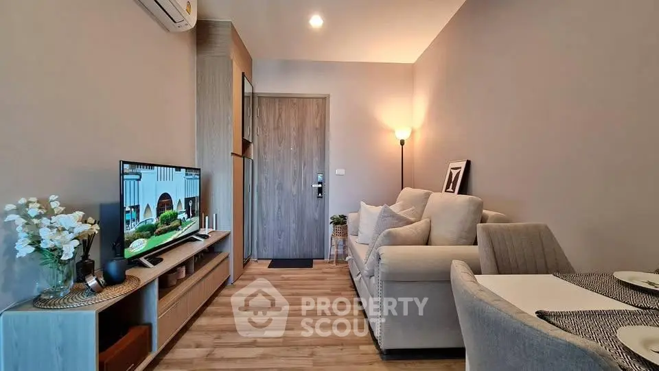 Modern living room with cozy seating and stylish decor in a contemporary apartment.
