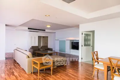 Spacious modern living room with elegant furniture and wooden flooring, perfect for relaxation and entertainment.