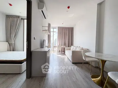 Modern open-plan living room with elegant decor and natural light