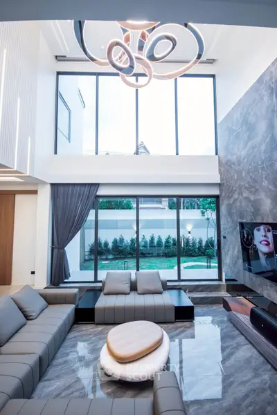 Luxurious modern living room with high ceiling and elegant chandelier