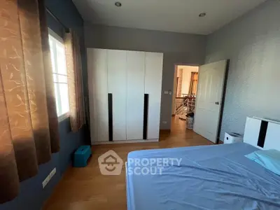 Spacious bedroom with modern wardrobe and natural light