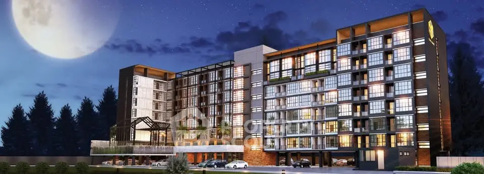 Stunning modern apartment building with illuminated facade under a moonlit sky, showcasing contemporary urban living.