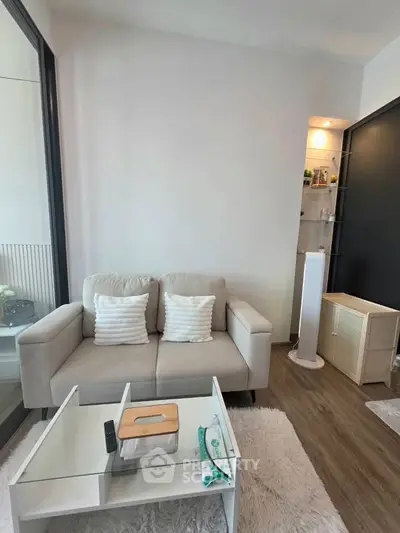 Modern living room with cozy sofa and stylish decor in a contemporary apartment.