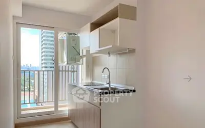Modern kitchen with open layout and balcony view in high-rise apartment