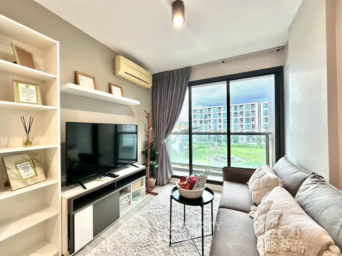 Modern living room with large window and cozy decor in urban apartment