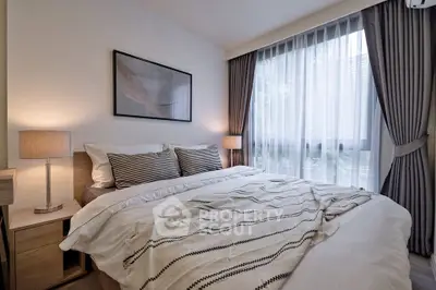 Cozy bedroom with elegant decor and large window for natural light