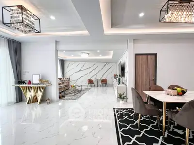 Luxurious open-plan living and dining area with modern decor and elegant lighting.
