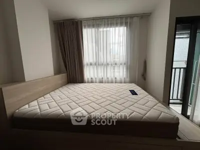 Spacious bedroom with large window and modern decor