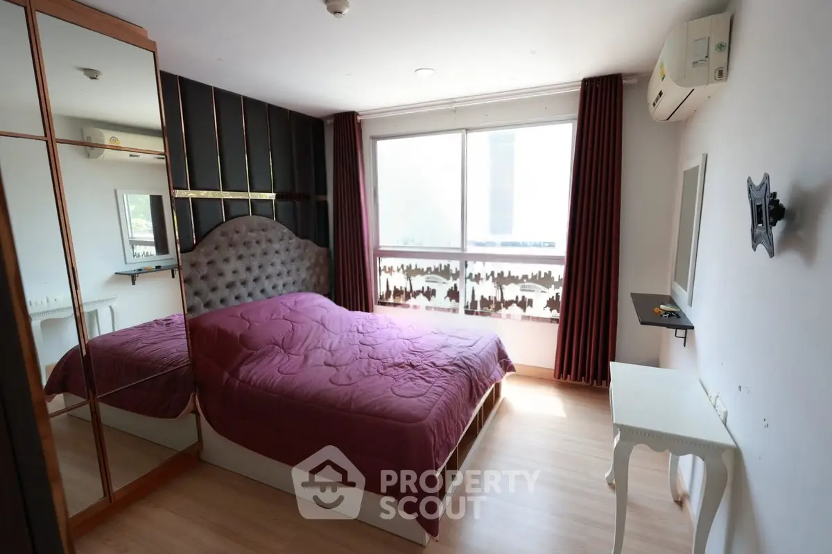 Modern bedroom with stylish decor, large window, and elegant furnishings in a cozy apartment.