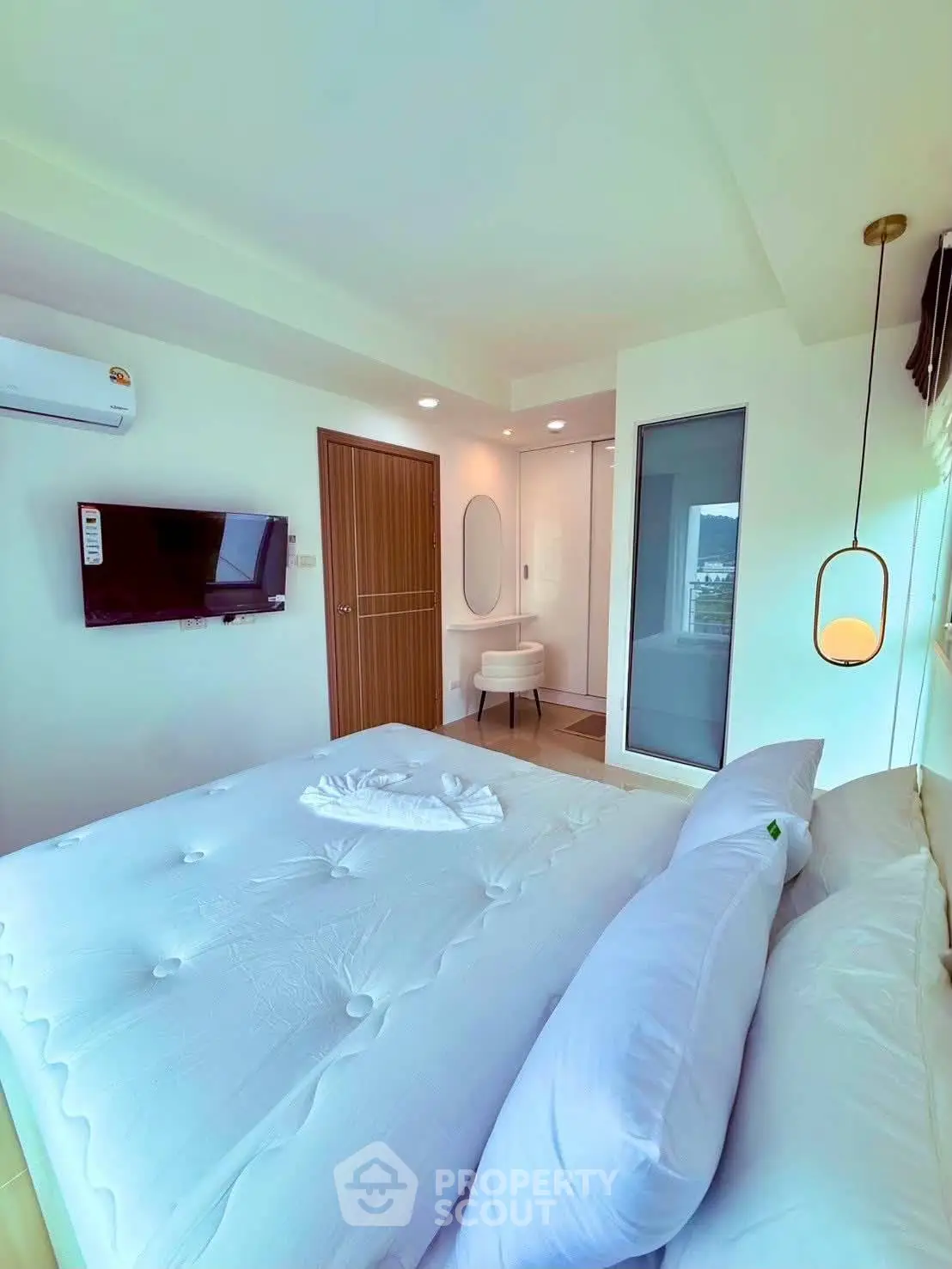 Modern bedroom with stylish decor, featuring a wall-mounted TV and air conditioning for comfort.