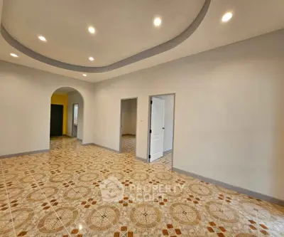 Spacious room with elegant tile flooring and recessed lighting, perfect for versatile living space.