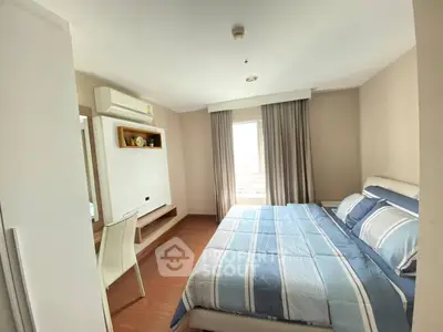 Spacious bedroom with modern decor and large window for natural light