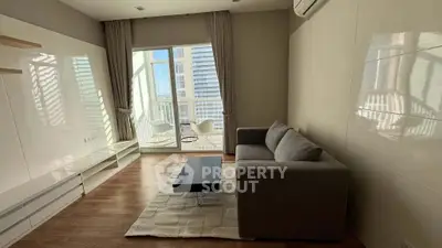 Modern living room with balcony and stylish furniture in high-rise apartment