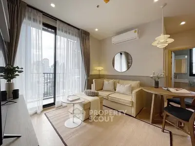 Modern living room with large windows and elegant decor in a high-rise apartment.