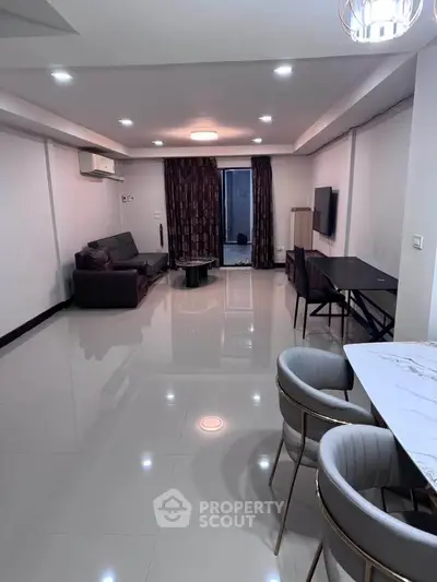 Spacious modern living room with sleek furniture and elegant lighting
