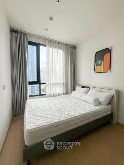 Modern bedroom with large window and city view, featuring minimalist decor and cozy ambiance.