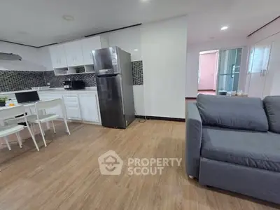 Spacious open-layout kitchen with modern appliances and cozy living area, perfect for contemporary living.