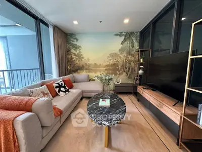 Luxurious living room with modern decor and scenic wallpaper, featuring a plush sofa and sleek entertainment unit.