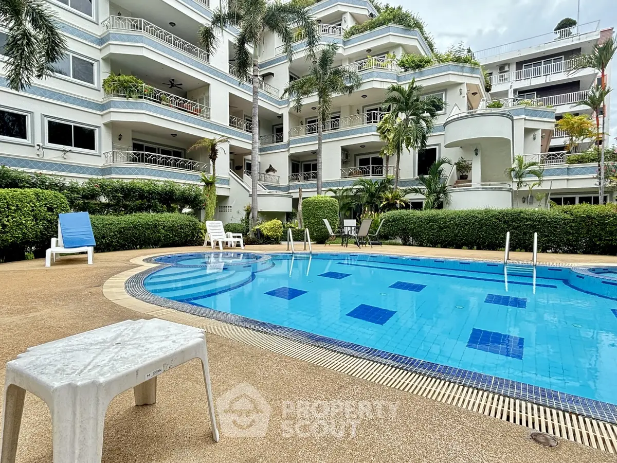 Luxurious apartment complex with inviting pool and lush greenery