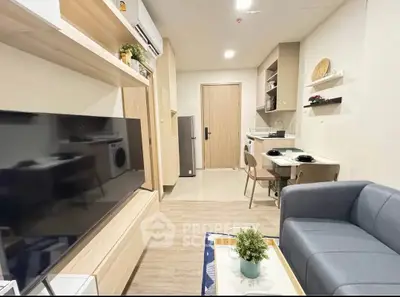 Modern living room with open kitchen, stylish furniture, and cozy ambiance in a contemporary apartment.