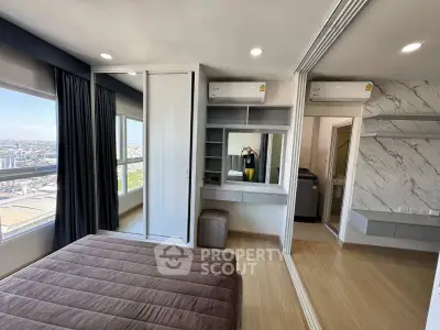 Modern bedroom with city view, featuring sleek built-in wardrobe and stylish decor.