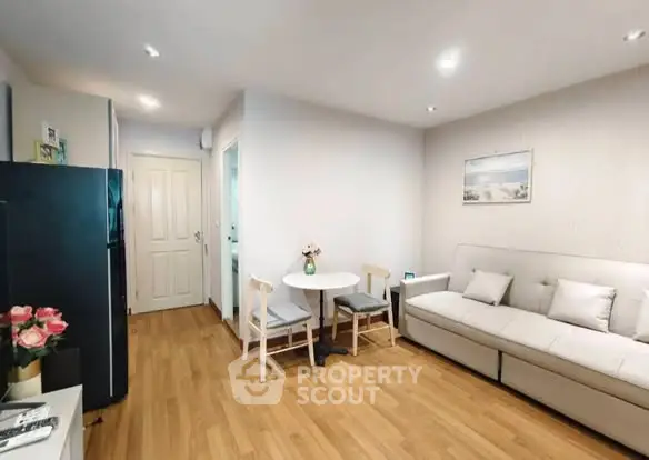 Charming living room with cozy sofa and dining area, perfect for relaxation and entertaining.
