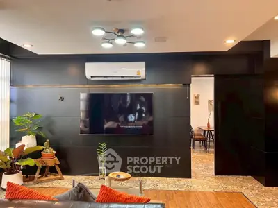 Modern living room with sleek black walls and stylish decor