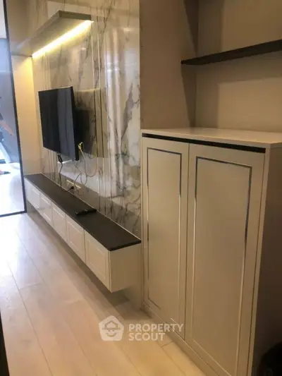Modern living room with sleek TV unit and marble accent wall