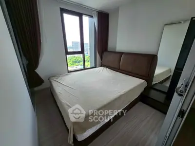 Cozy bedroom with large window offering a scenic view, featuring a comfortable bed and modern decor.
