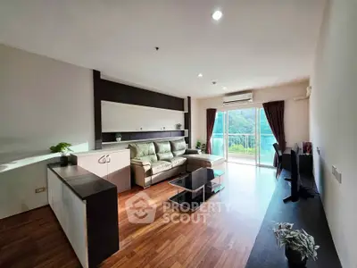 Spacious living room with modern decor and balcony view