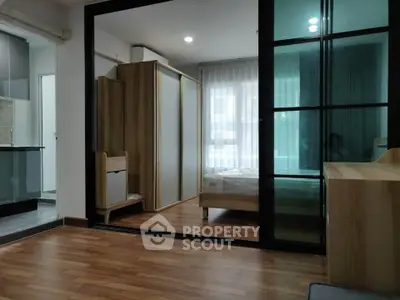 Modern apartment interior with sliding glass doors and wooden flooring
