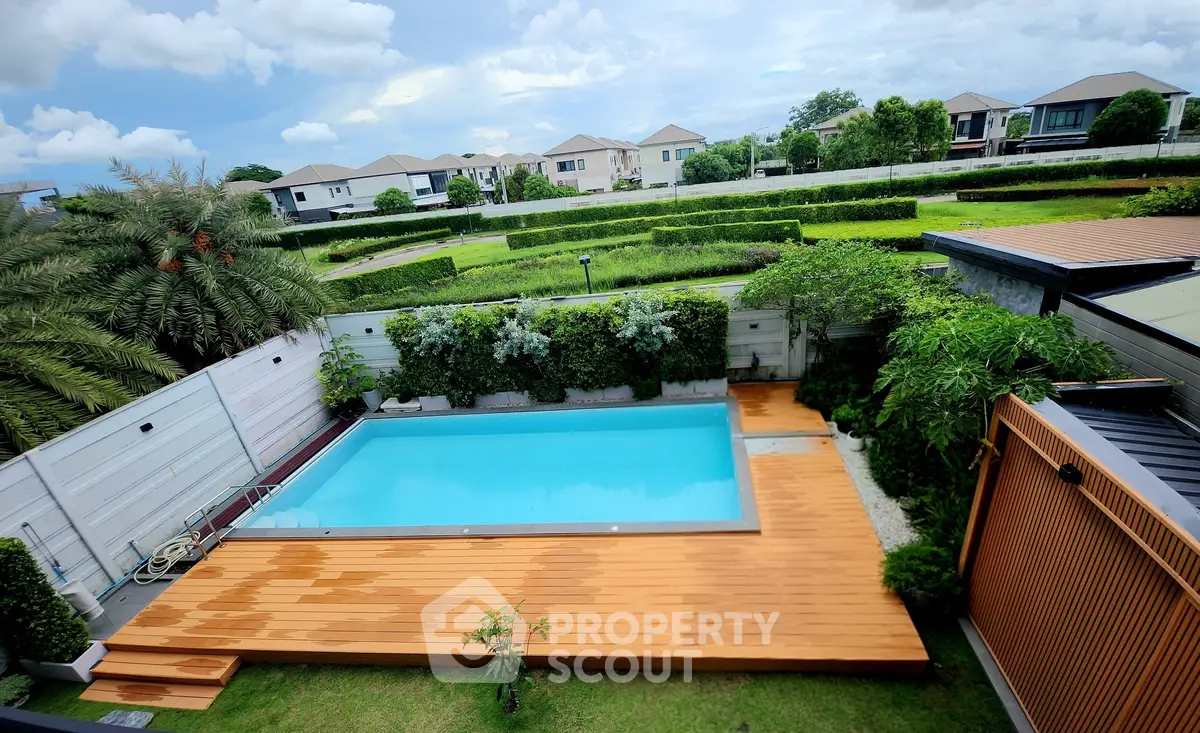 Luxurious backyard with pristine pool and lush greenery, perfect for relaxation and entertainment.