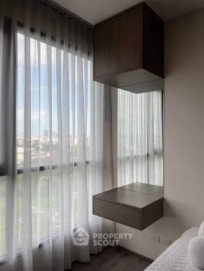 Modern bedroom with large windows and floating wooden shelves, offering a bright and airy atmosphere.