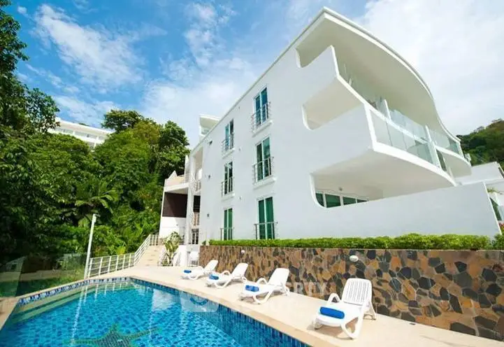 Luxurious modern building with pool and lush greenery, perfect for upscale living.
