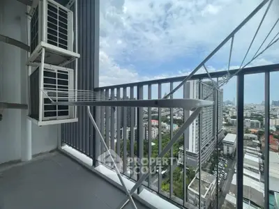 High-rise balcony with cityscape view and air conditioning units, perfect for urban living.