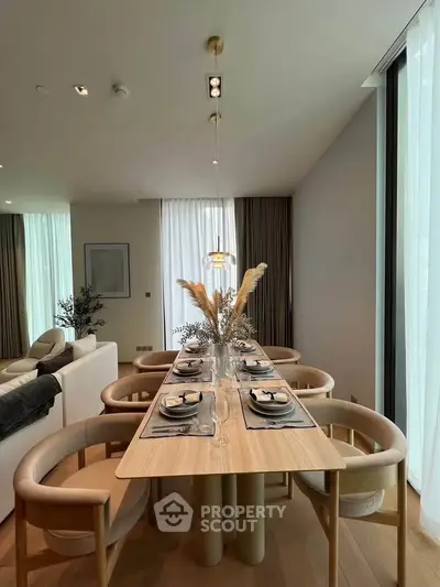 Elegant dining area with modern decor and natural light in a luxurious apartment.