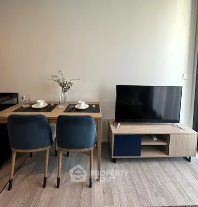 Modern living room with stylish dining area and sleek TV setup
