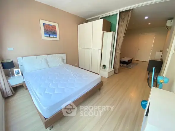 Spacious bedroom with modern furnishings and ample natural light