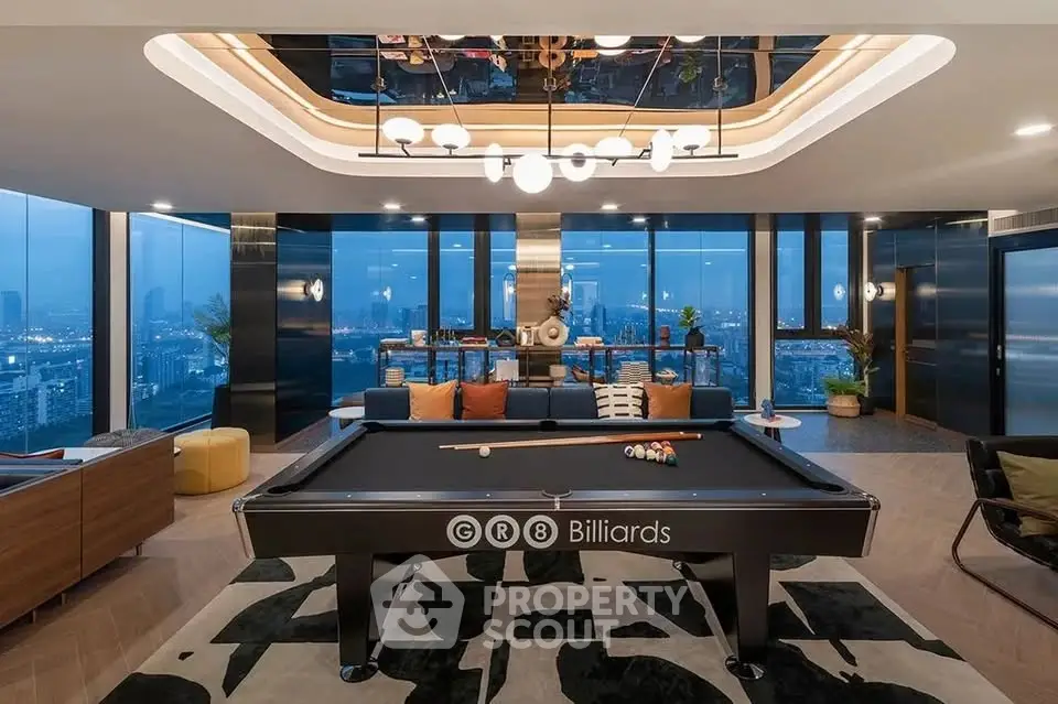 Luxurious penthouse living room with billiards table and stunning city view