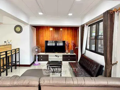 Spacious living room with modern decor and ample natural light