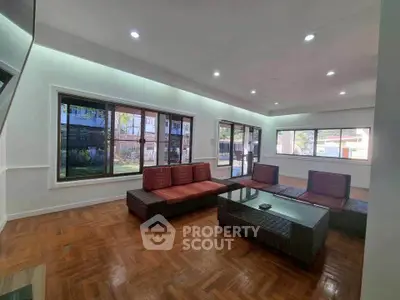 Spacious living room with modern furniture and large windows offering natural light.
