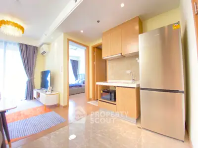 Modern open-plan living room with kitchen and bedroom view