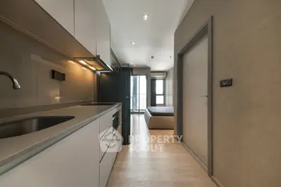 Modern apartment interior with sleek kitchen and cozy bedroom view