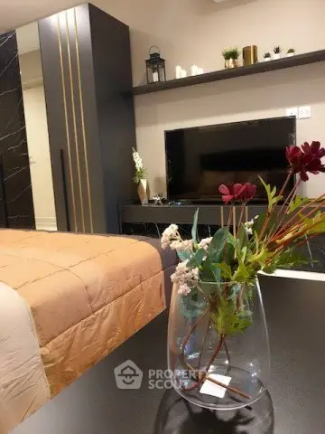 Stylish bedroom with modern decor and elegant furnishings, featuring a cozy bed and sleek entertainment unit.
