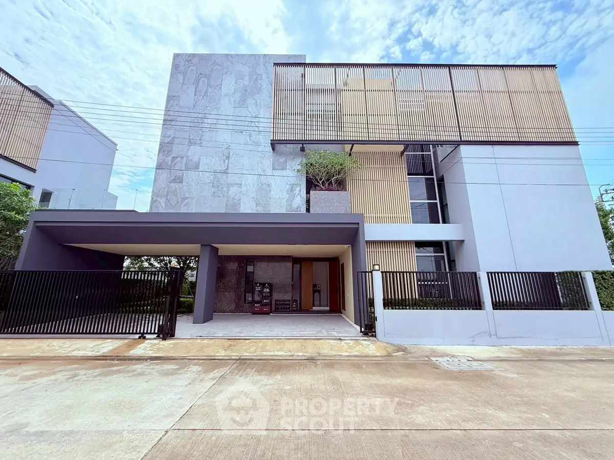 Modern architectural home with sleek facade and gated entrance