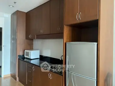 Modern kitchen with wooden cabinets and stainless steel appliances