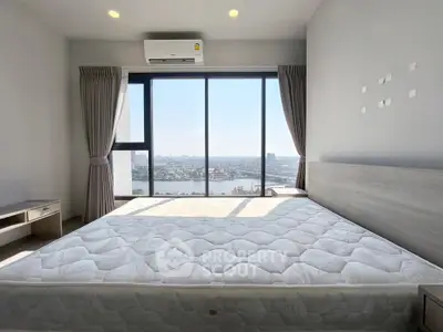 Spacious bedroom with panoramic city view and large windows
