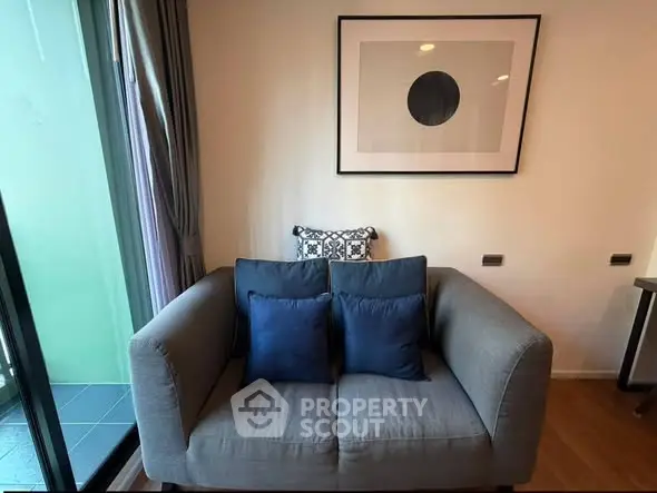 Cozy living room with modern sofa and stylish wall art, perfect for relaxation.