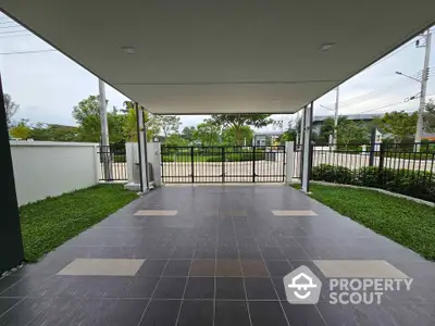 Spacious covered parking area with modern tiled flooring and garden view