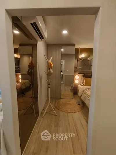 Cozy bedroom with modern decor and mirrored closet doors, perfect for relaxation.